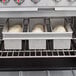 A Chicago Metallic aluminized steel bread loaf pan with 3 loaves of bread inside.