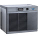 A grey rectangular Follett water cooled ice machine with a vent.