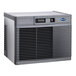 A commercial water-cooled ice machine with a gray exterior and front ventilation grill.