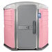 A pink and white PolyJohn wheelchair accessible portable restroom.