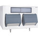 A white Follett ice storage bin with a grey border and grey bins.