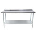 An Advance Tabco stainless steel work table with a galvanized shelf underneath.