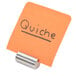 A paper note with the word "quiche" on a silver American Metalcraft table card holder.