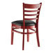A Lancaster Table & Seating wooden chair with a black cushion.