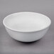 a white bowl on a gray surface