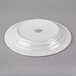 A white Libbey Rigel Constellation porcelain plate with a circular design on it.