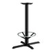A Lancaster Table & Seating black cast iron bar height table base with a round foot ring.