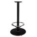 A Lancaster Table & Seating black cast iron bar height table base with a round metal ring.