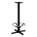 A Lancaster Table & Seating black cast iron bar height table base with a metal foot ring.