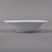 a white bowl on a gray surface