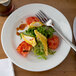 A Libbey Rigel Constellation porcelain plate with a fork and a plate of food.