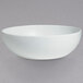 A white G.E.T. Enterprises Bugambilia deep round bowl on a gray background.