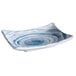 A close-up of a blue and white rectangular melamine plate with swirls on it.