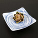 An Elite Global Solutions square melamine bowl with a Van Gogh artichoke design on it.