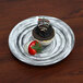 An Elite Global Solutions black melamine plate with a chocolate cupcake and a strawberry on it.
