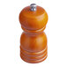 A close-up of a wooden Acopa salt and pepper mill with a metal knob.