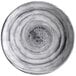 A close-up of a black Elite Global Solutions round melamine plate with swirls on it.