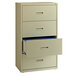 A Hirsh Industries putty lateral file cabinet with three open drawers.