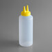 A plastic bottle with a yellow lid.