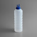 A clear plastic Vollrath squeeze bottle with a blue cap.