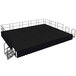 A black National Public Seating stage with black skirting.