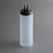 A clear plastic Vollrath Twin Tip squeeze bottle with a brown cap.