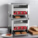 An Avantco commercial conveyor toaster with bread slices on a rack.