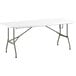 A Lancaster Table & Seating white heavy-duty plastic bi-folding table with metal legs.