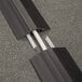 Two black D-Line medium duty floor cable covers over cables.