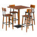 A Lancaster Table & Seating square table with a live edge and four bar stools with metal legs.