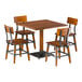 A Lancaster Table & Seating live edge wooden table with metal legs and four wooden chairs.
