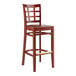 A Lancaster Table & Seating mahogany wood bar stool with a mahogany wood seat and window back.