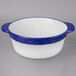 A white casserole dish with a blue rim.