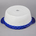 A white ceramic casserole dish with blue trim.