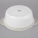A white round Tuxton China casserole dish with a lid.