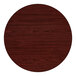 A round, reversible table top with a cherry wood finish, designed for bar height tables.