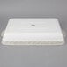 A white rectangular Tuxton casserole dish with a white lid.