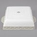 A white square Tuxton casserole dish with a square design on the lid.