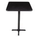 A black square table with a black pole and base plate.