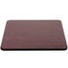 A rectangular wood table top with a cherry wood finish and a black edge.