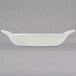 A white rectangular Hall China au gratin dish with handles.