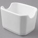 A close-up of a white square Tuxton sugar packet holder.