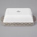 A white rectangular Tuxton casserole dish with a grey truffle design on the surface.