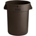 A brown plastic Lavex commercial trash can.