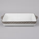 A white and gray rectangular Tuxton china casserole dish.