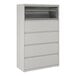 A gray five-drawer lateral file cabinet with a roll-out binder storage compartment at the top.
