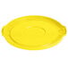 A yellow plastic lid for a Lavex commercial trash can with a circle in the middle.
