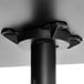 A black metal pole with a round black base plate.
