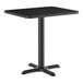 A standard height rectangular table with a reversible cherry or black top and a black cast iron base.