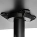 A black metal pole with a black metal base plate for a Lancaster Table & Seating table.